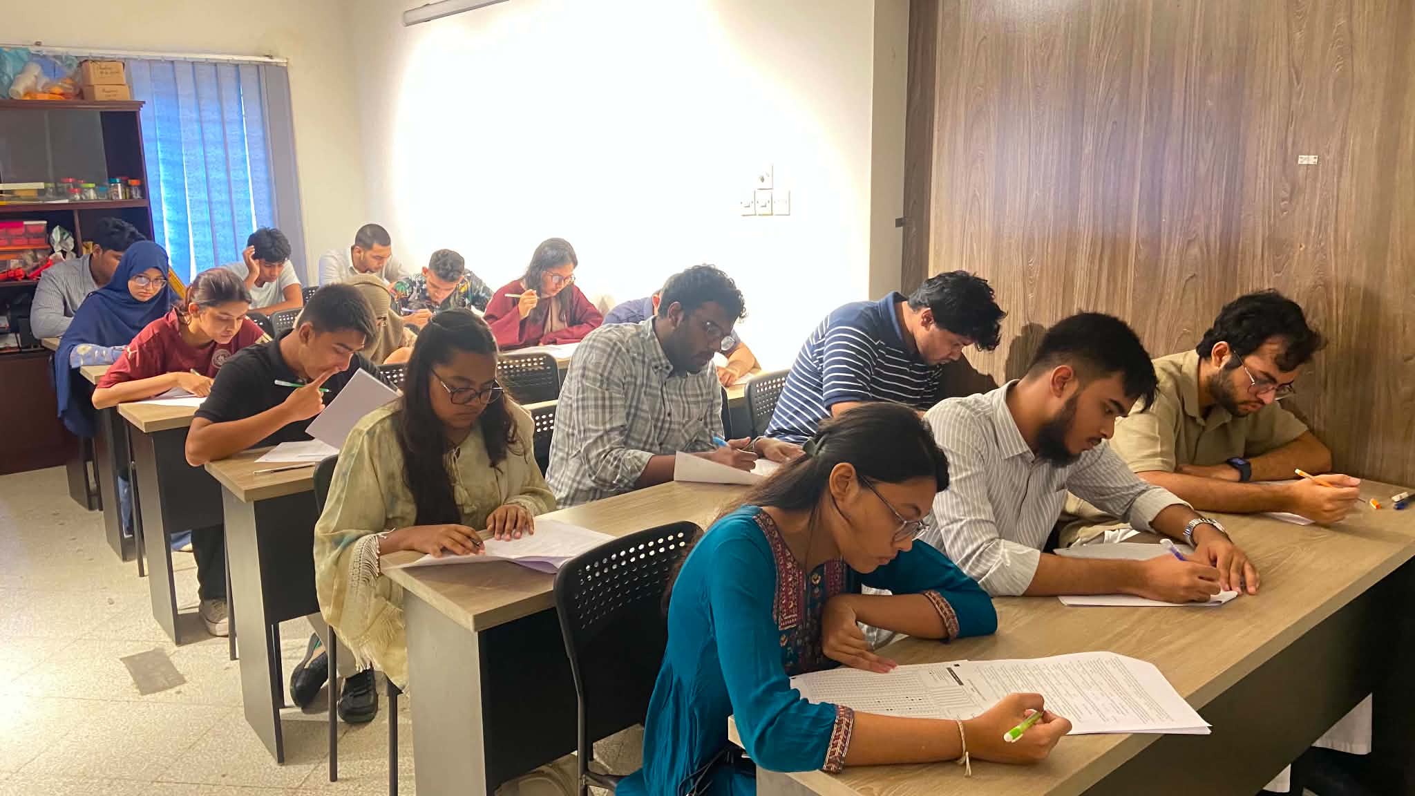 Students concentrating on their papers during an offline mock test